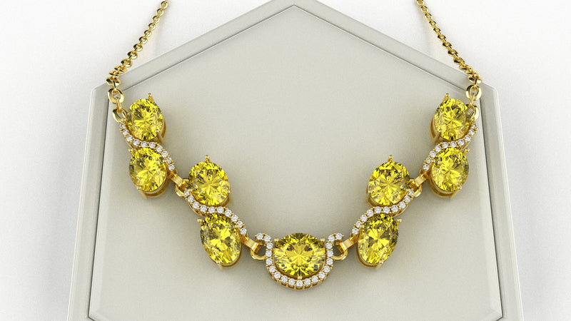 Necklace with yellow gemstones and gold chain on a white background
