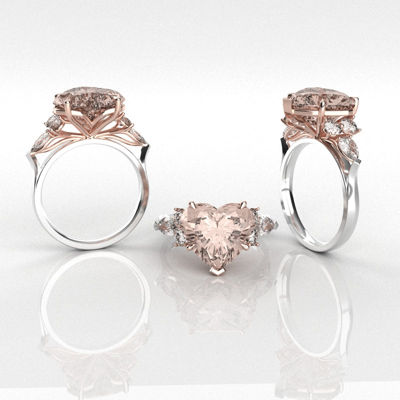 Two rose gold rings with heart-shaped pink gemstones on a reflective surface.