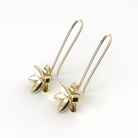 Gold floral earrings on a white background